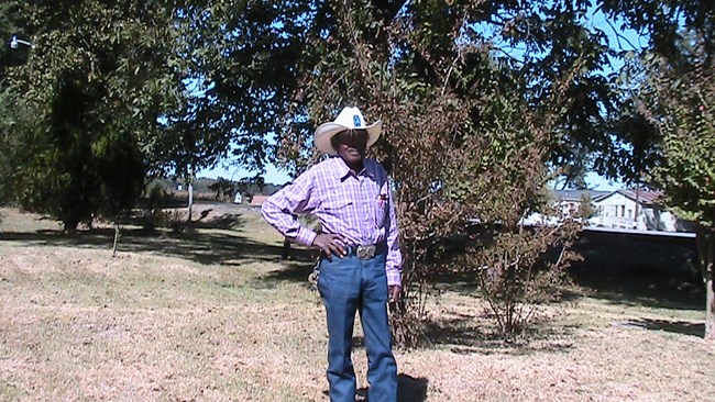 James Helaire stands in a field.