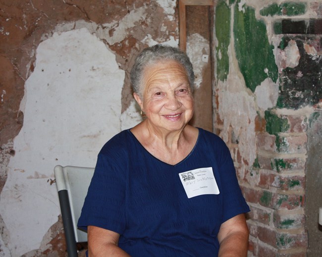 Mary Sue Metoyer sitting in the Oakland overseer's house