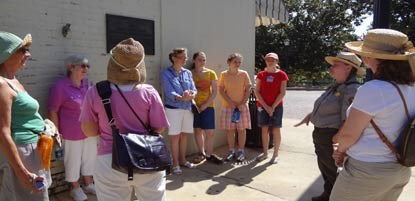 A ranger talking with visitors on a walking tour of downtown Natchitoches. A ranger talking with visitors on a walking tour of downtown Natchitoches.