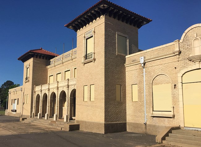 The Texas & Pacific Railway Depot in Natchitoches is a yellow brick building featuring two towers.