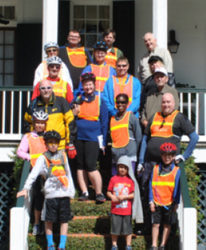 Visitors on steps, wearing safety helmets and vests