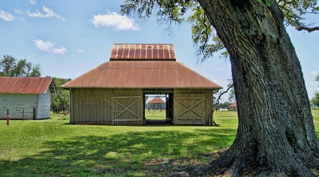 Oakland Mule Barn with Overseer's House in the distance