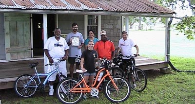 Bike Riders posing in front of Oakland's tenant cabin.