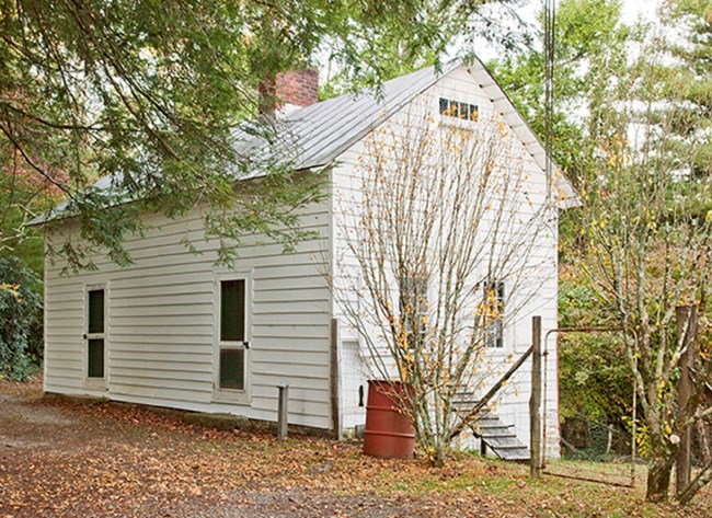 Wash House near Sandburg Home Single story white painted building with 2 doors on the front and 2 windows on the side