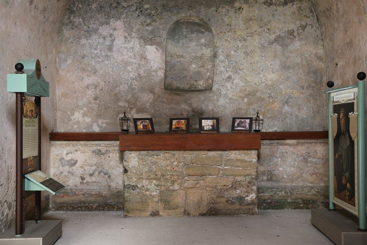 Chapel room with altar and two exhibit panels.