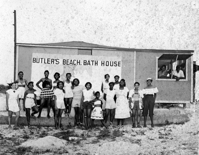 Beach goers assembled for a group portrait by the bath house at Butler Beach