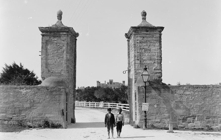 Two African American children standing in front of City Gate in 1900.