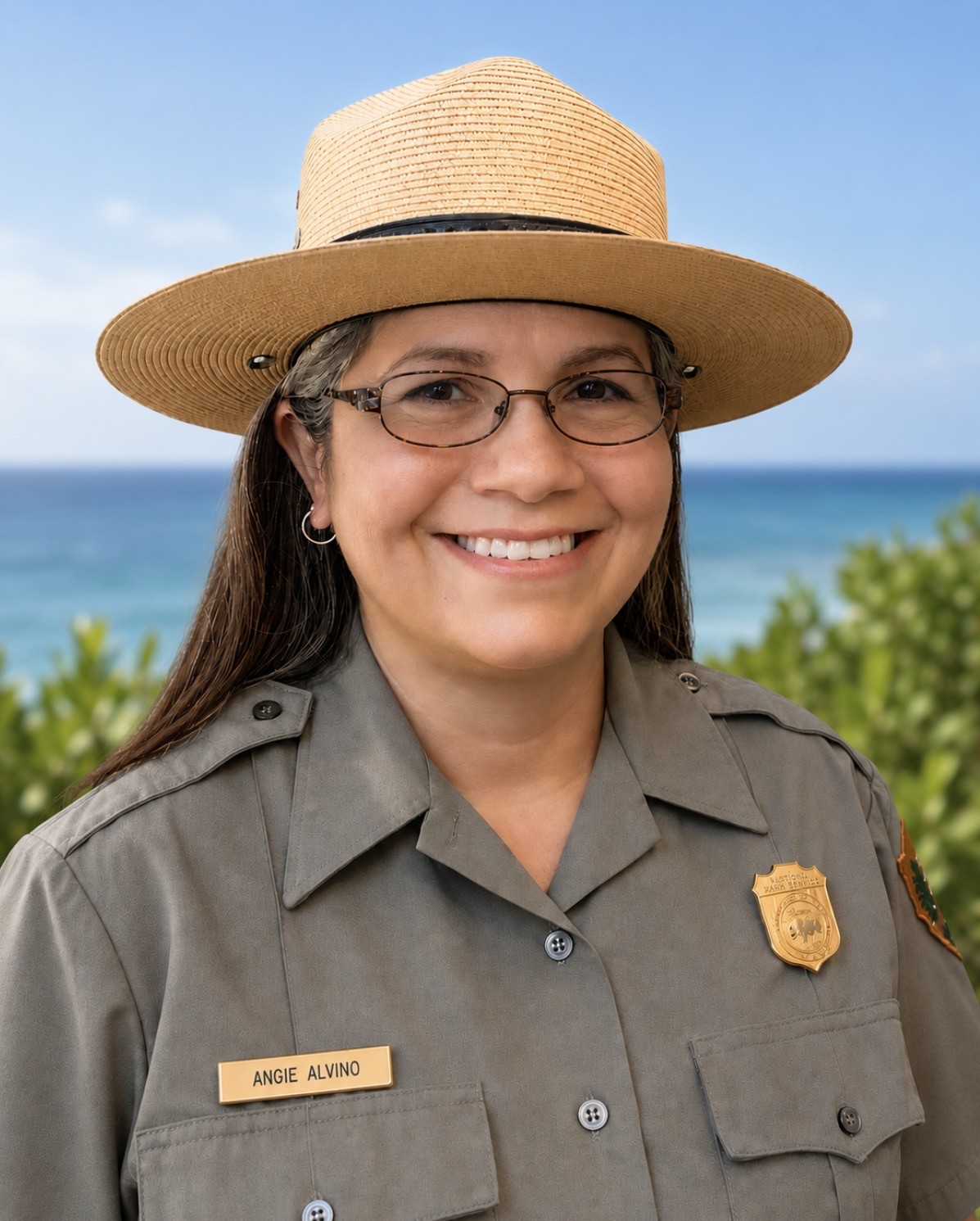 Superintendent Alvino standing in front of blue water and greenery.