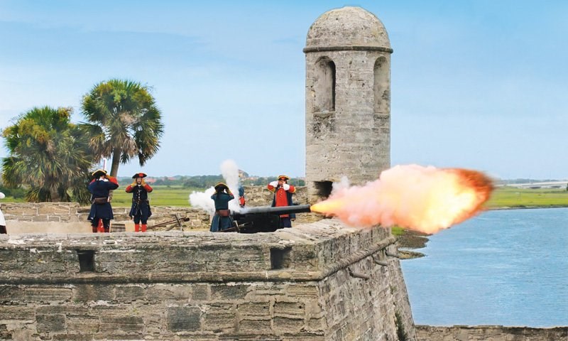 Soldiers firing a cannon