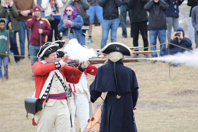 British soldiers fire muskets