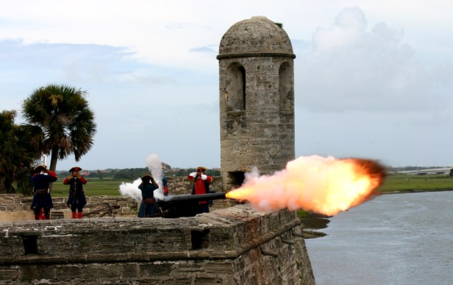 Cannon firing from the top of the fort