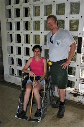 Two visitors one sitting in a wheelchair.