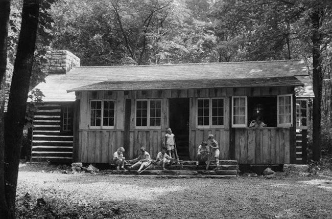 Campers from the League gather on the front porch of the Craft Shop at Camp Greentop.