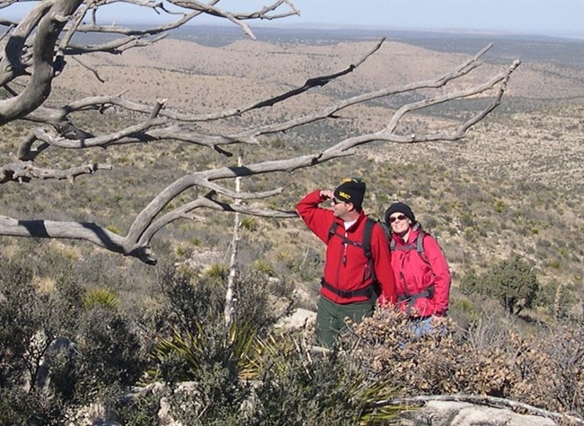 Two hikers in warm clothes hike in the backcountry