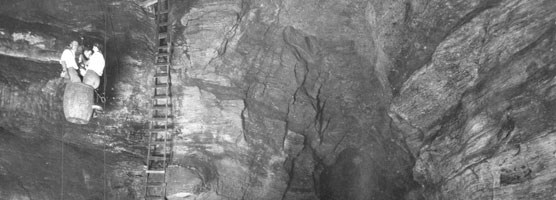 Early visitors entering Carlsbad Cavern in an old guano mining guano.