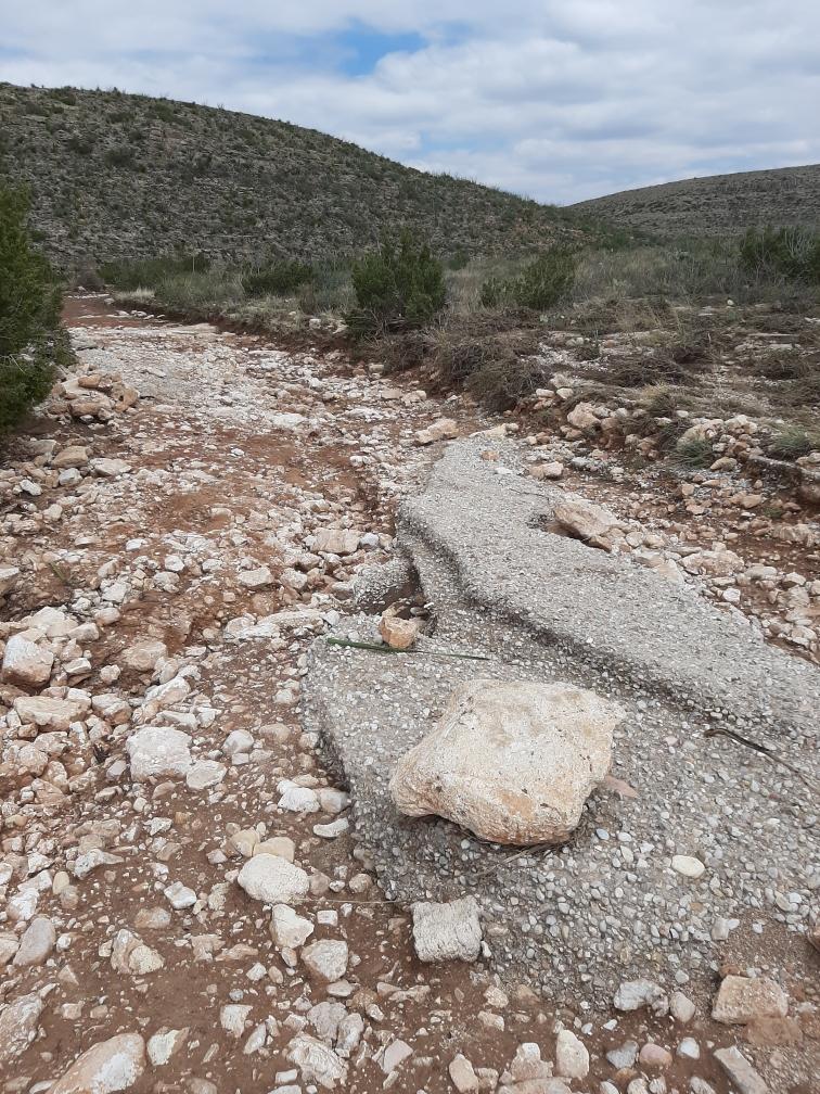 A photo of major flood damage to the Walnut Canyon Desert Drive.