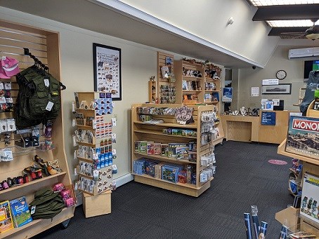 Wooden displays with store items like posters, games, and books