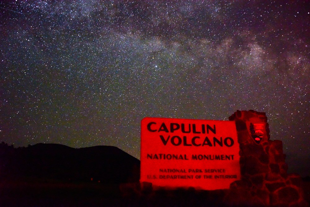 Capulin entrance sign under milky way