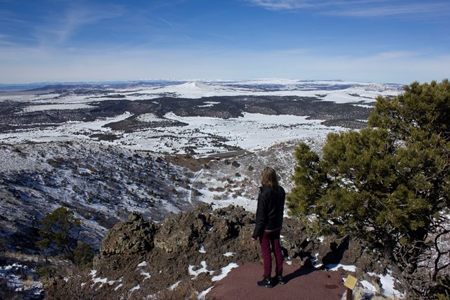 Visitor taking in the views on the Volcano Rim Trail