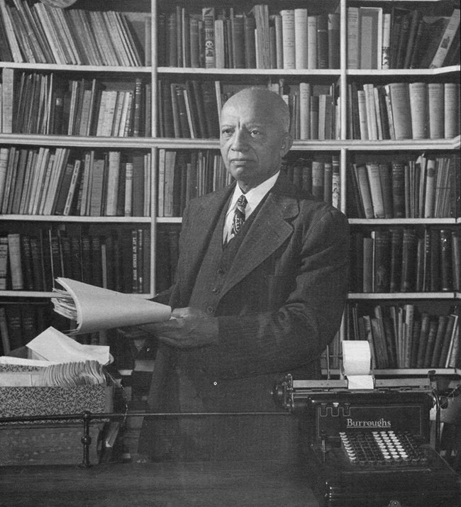 Dr. Carter G. Woodson in his library