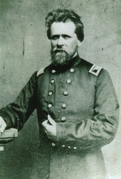 An 1860s half-portrait photo shows a bearded army officer posing hand-in-waistcoat.