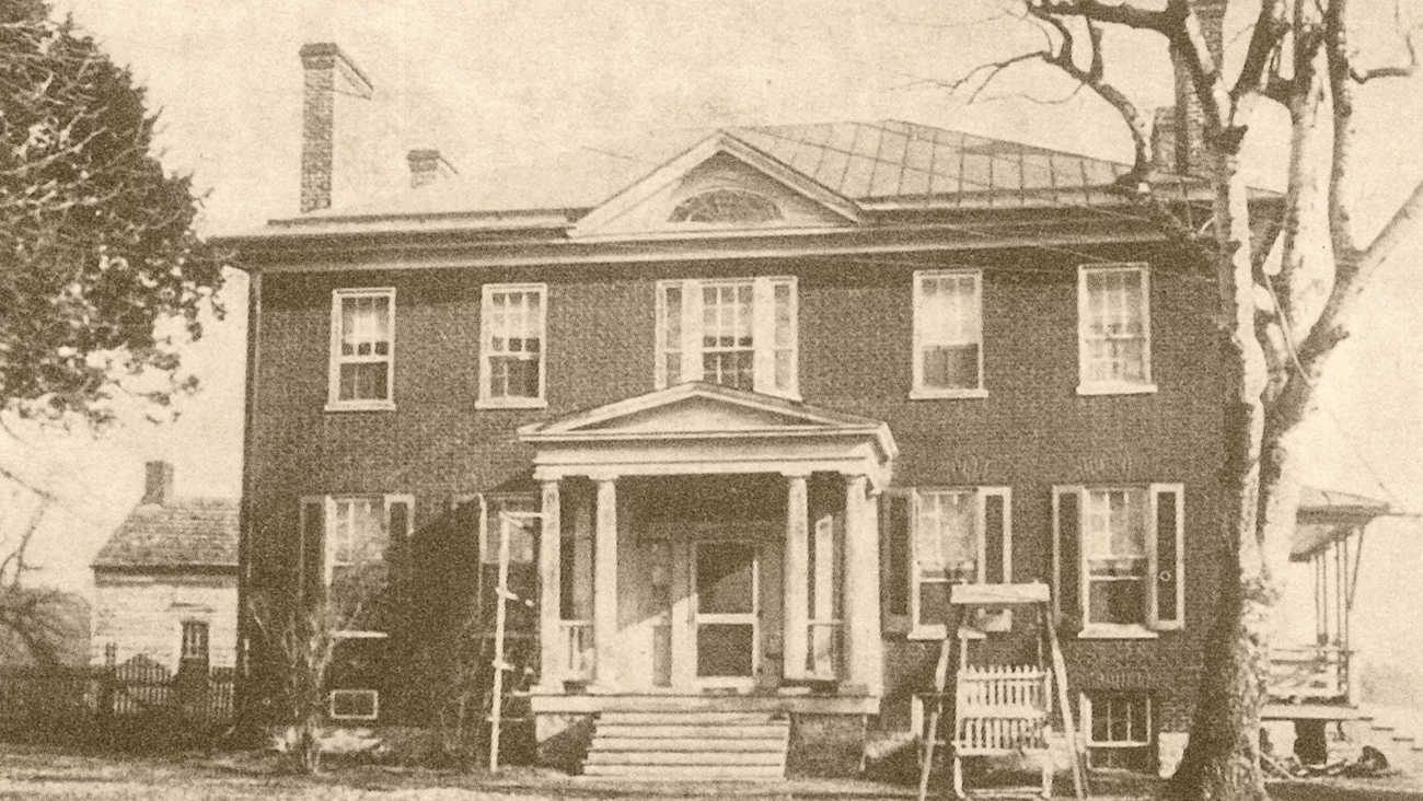 Long Meadow House A sepia photo shows an antebellum style mansion with a brick façade and white trim.