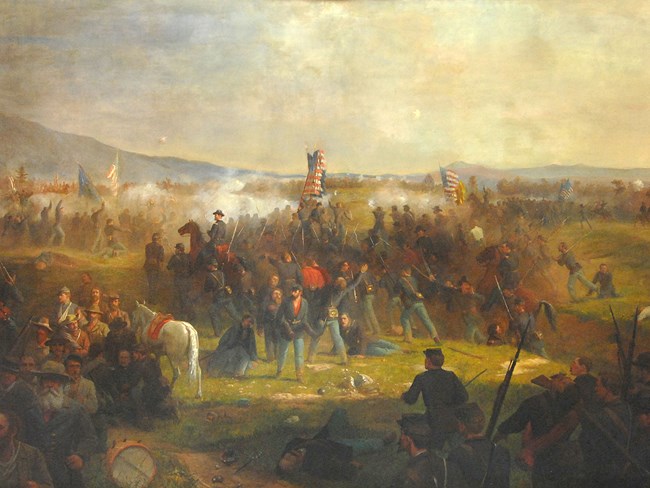 A mural painting depict Civil War soldiers rallying to the US flag amid battle.