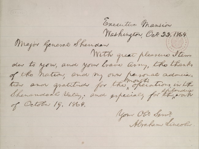 A handwritten letter expresses gratitude to a general for victory in battle.