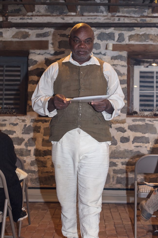Joseph McGill in period dress reading Jackson's freedom papers