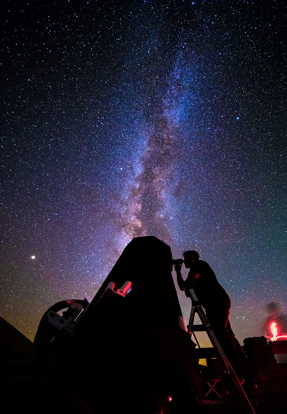 Photo Copyright: Bettymaya Foott
Starry sky with silhouette of a man looking through a telescope. Starry sky with silhouette of a man looking through a telescope.