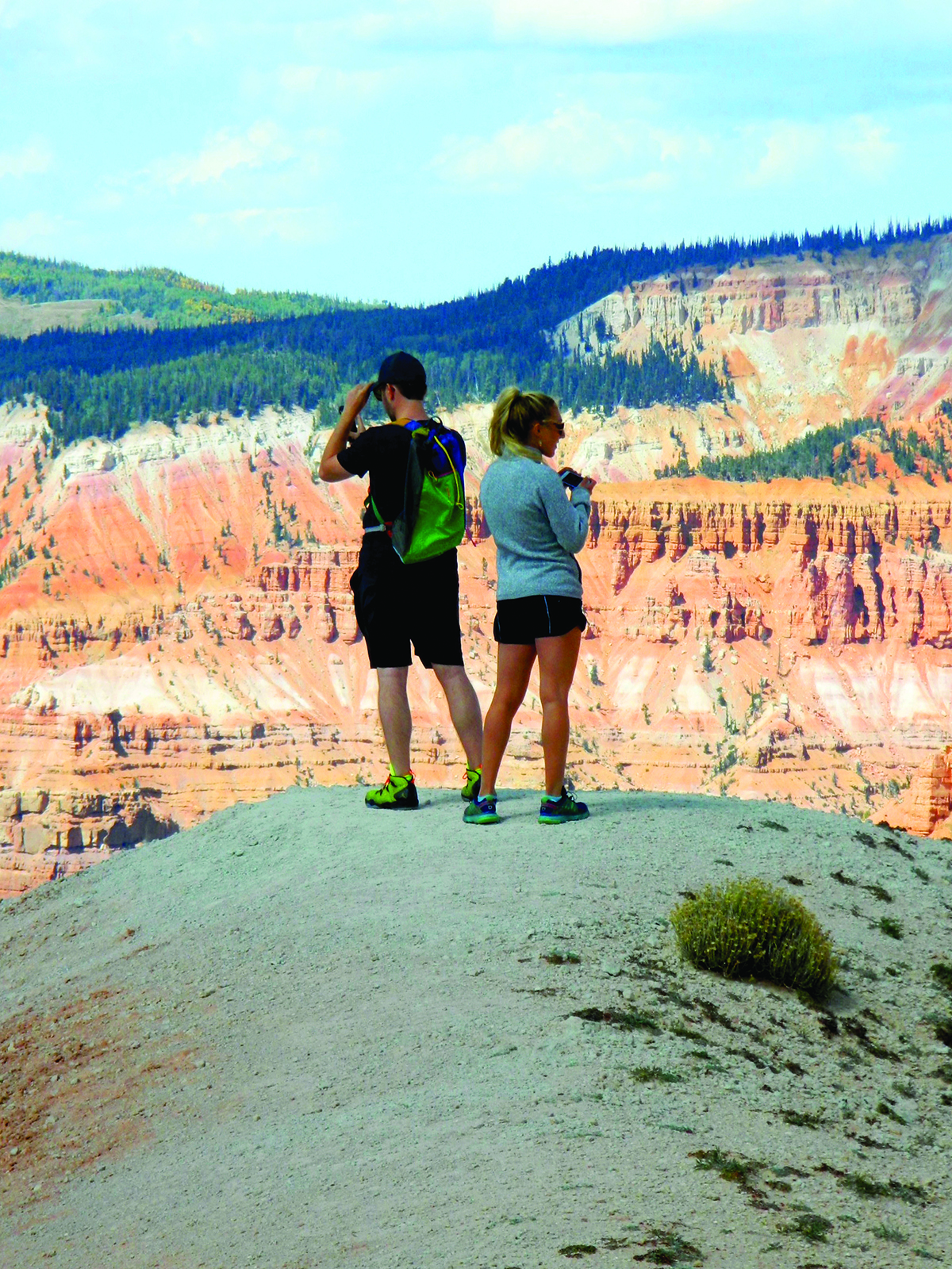 DSCN3240 Young man and woman photographing pink scenic cliffs from an overlook.