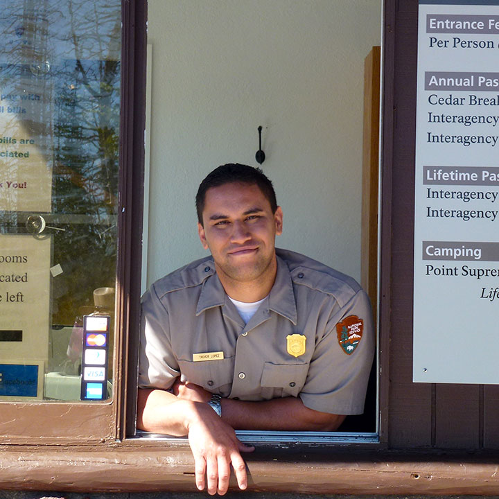 Park employee at fee booth Park employee at fee booth