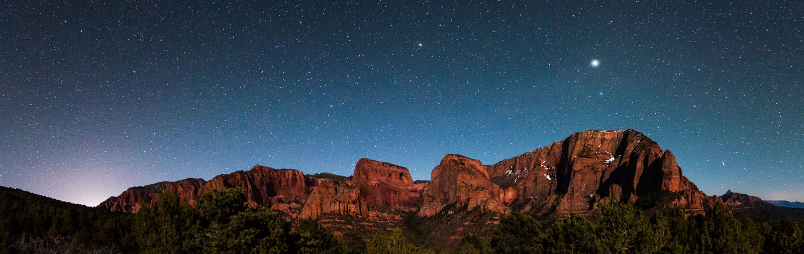 Red cliffs under a starry night sky. Red cliffs under a starry night sky.