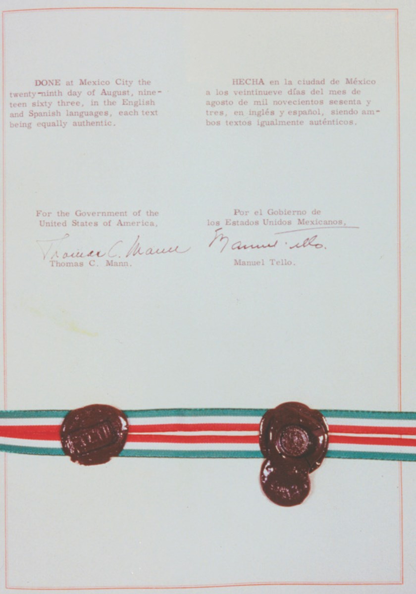 Color photo of the signature page of the Chamizal Convention of 1963 containing the signatures and wax seals of US Ambassador Thomas C. Mann and Mexico's Secretary for Foreign Relations Manuel Tello.