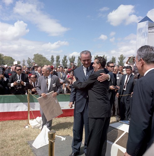 Two presidents embrace in front of crowd. Two presidents embrace in front of crowd.