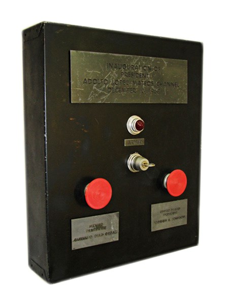 Black box with a plaque, small light, key switch, and two large red buttons