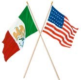 Crossed flag poles with Mexican flag (red, white, and green vertical bars and eagle emblem) and US flag (red and white stripes with field of blue bearing four straight rows of stars)
