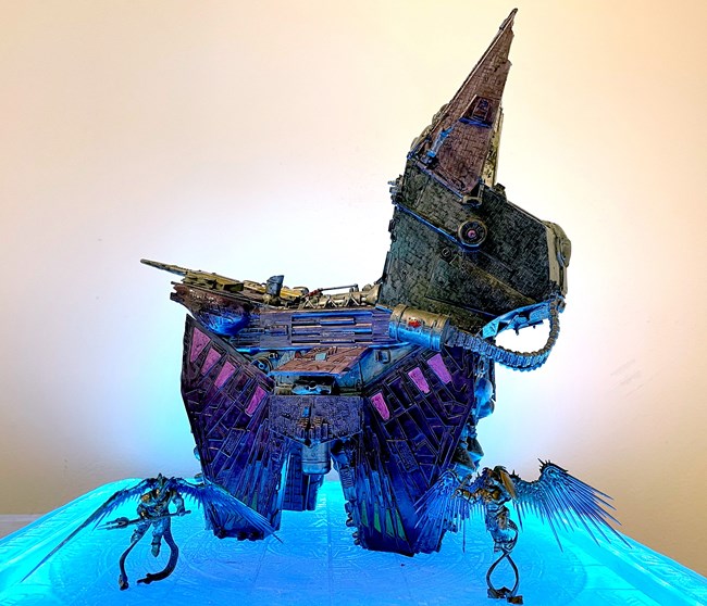 A sculpture in the shape of a pinata animal, made out of various reclaimed materials.