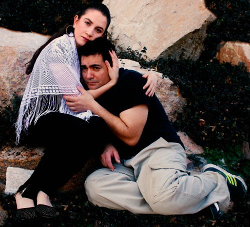 Los Actores perform Bernabé woman and young man seated, embracing