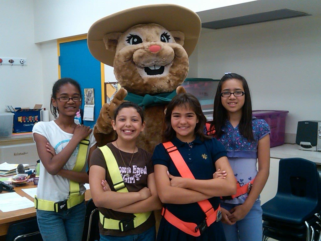 Chami ground squirrel mascot with crossing guard children in a classroom. Chami ground squirrel mascot with crossing guard children in a classroom.