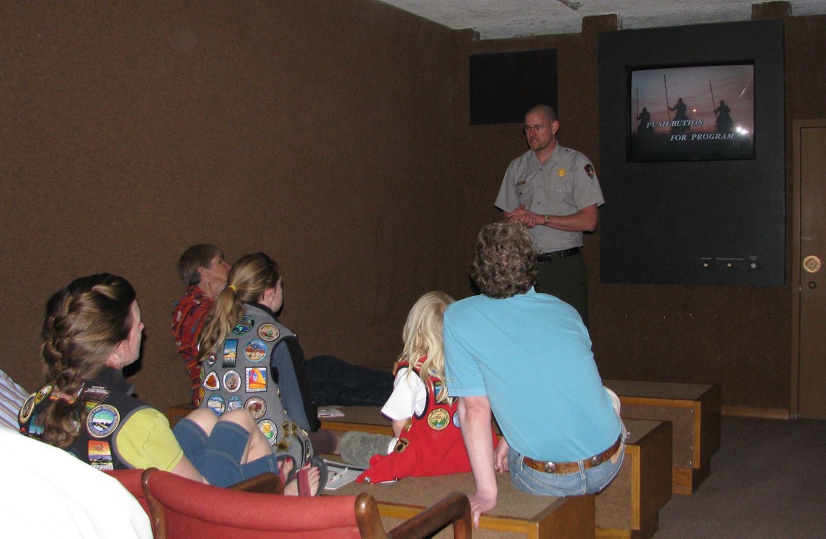 Ranger giving talk to scout group in mini-theater. Ranger giving talk to scout group in mini-theater.