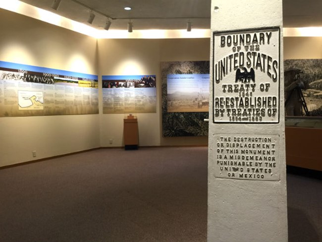 Boundary monument placard in foreground with exhibit walls in background Boundary monument placard in foreground with exhibit walls in background