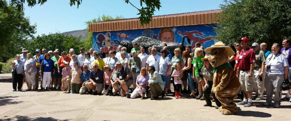 A large group of people pose for photo with squirrel mascot. A large group of people pose for photo with squirrel mascot.