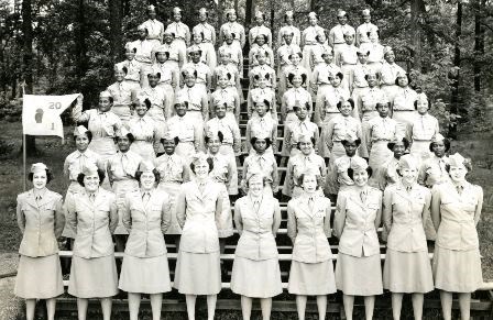 Group photo of a company of African American female soldiers with a row of white training officers.
