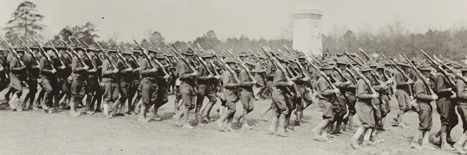 Doughboys-in-review-in-front-of-Monument World War I soldiers marching in front of a monument