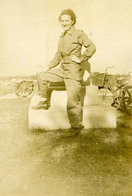 A female soldier during World War II leaning on a monument at Chickamauga