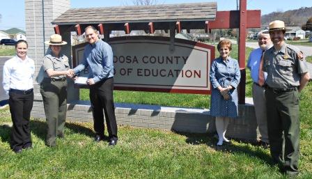 Eastern National and park staff present a check to the Catoosa County Board of Education