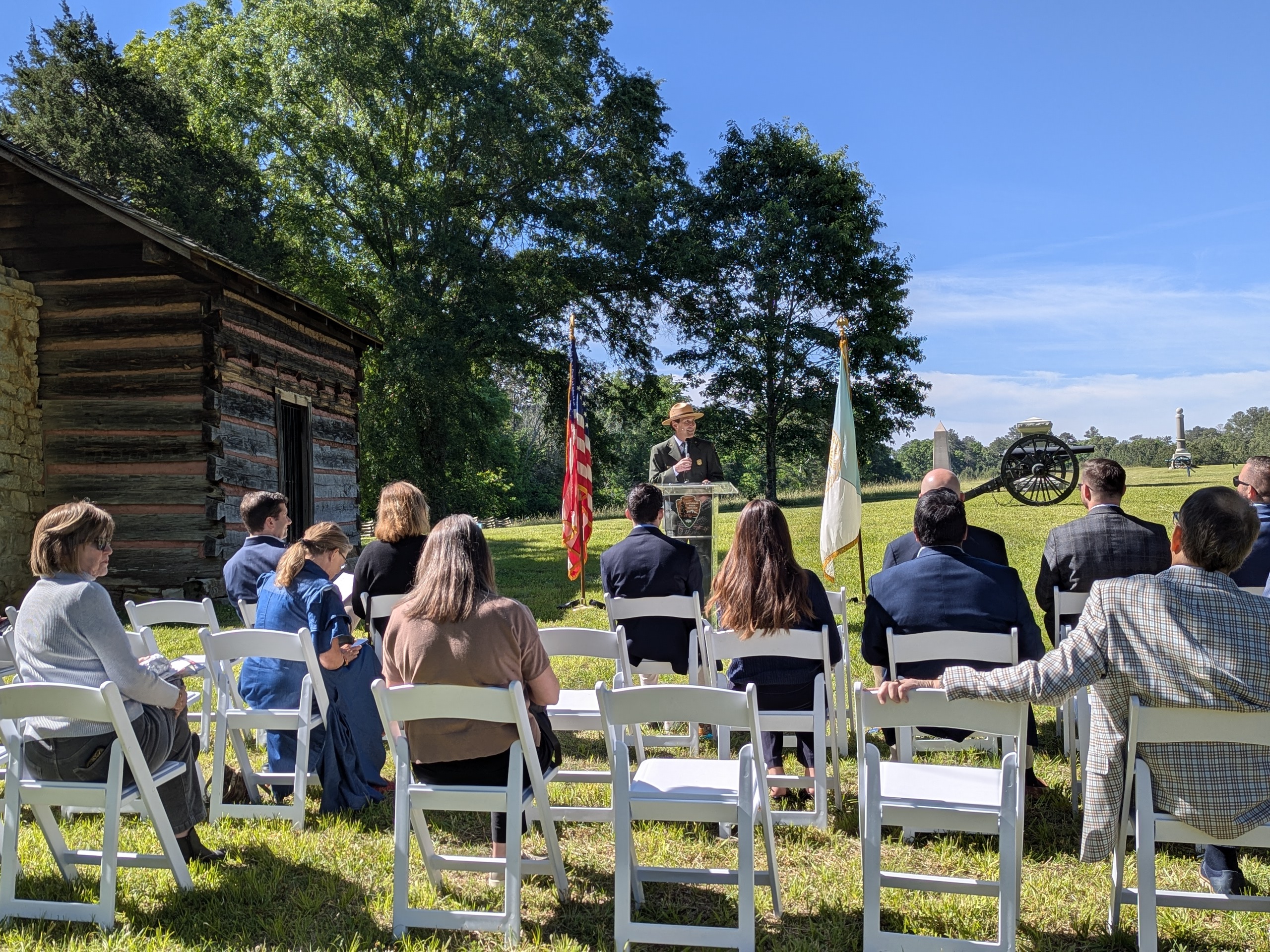 Superintendent Brad Bennett providing remarks on May 8, 2026, to a crowd seated in front of the re-created Brotherton Cabin in Chickamauga Battlefield.