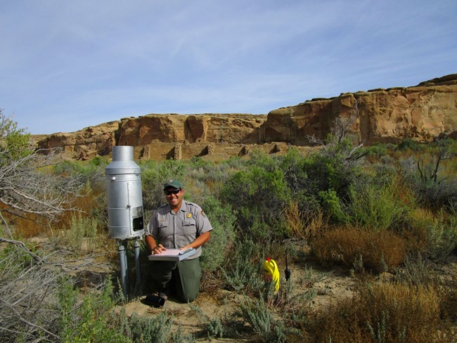 Park Staff member using a precipitation gauge.