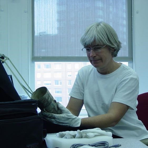 Patricia Crown examining a cylinder jar
